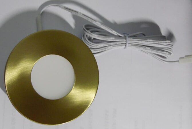 Estar LED brushed gold ring shown on light
